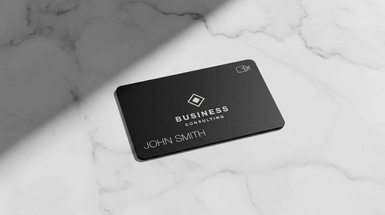 Black metal business card with engraved logo